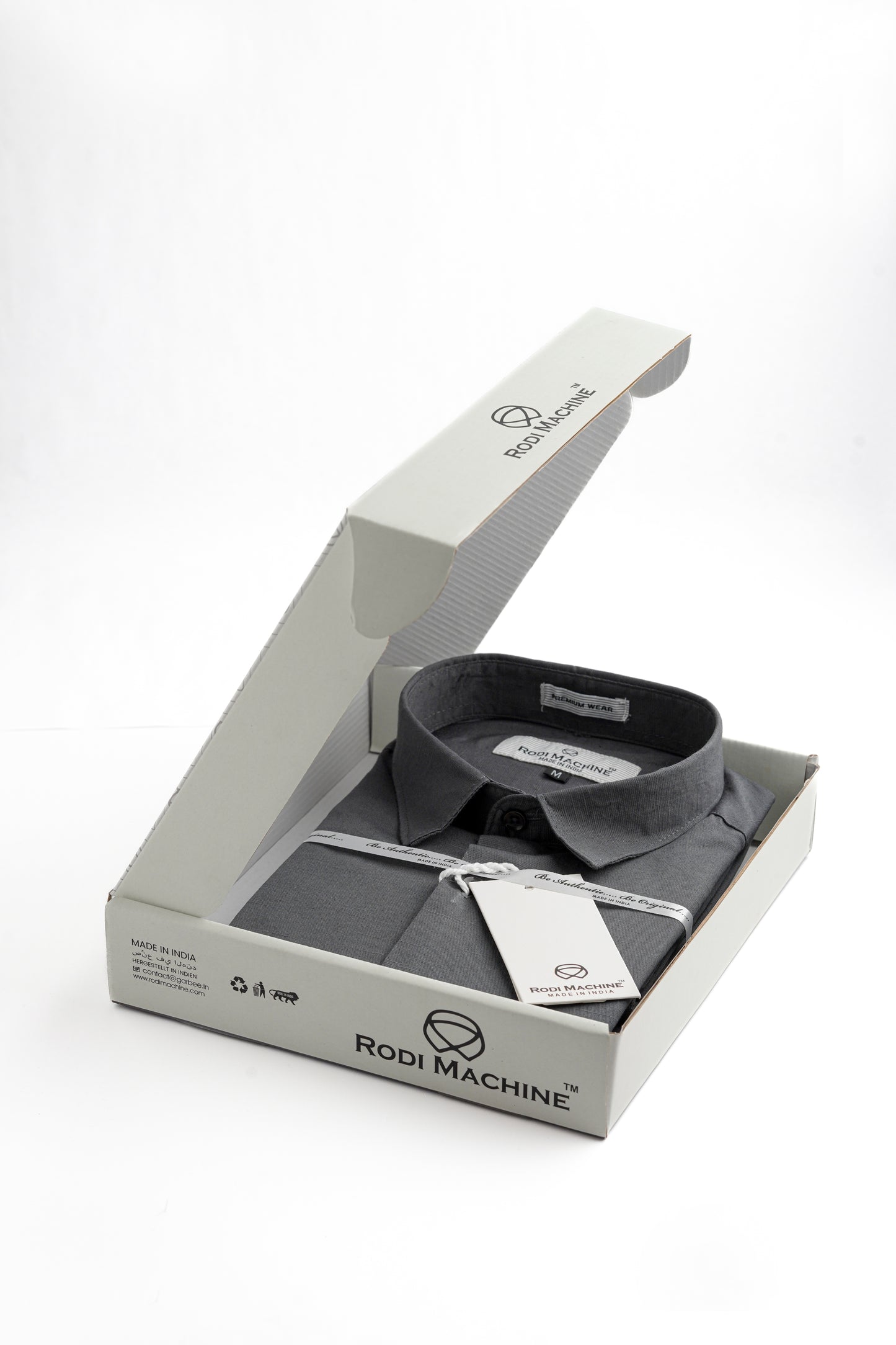 Ash colour Rodi Machine shirt in an open box with 'Rodi Machine' branding on a white background