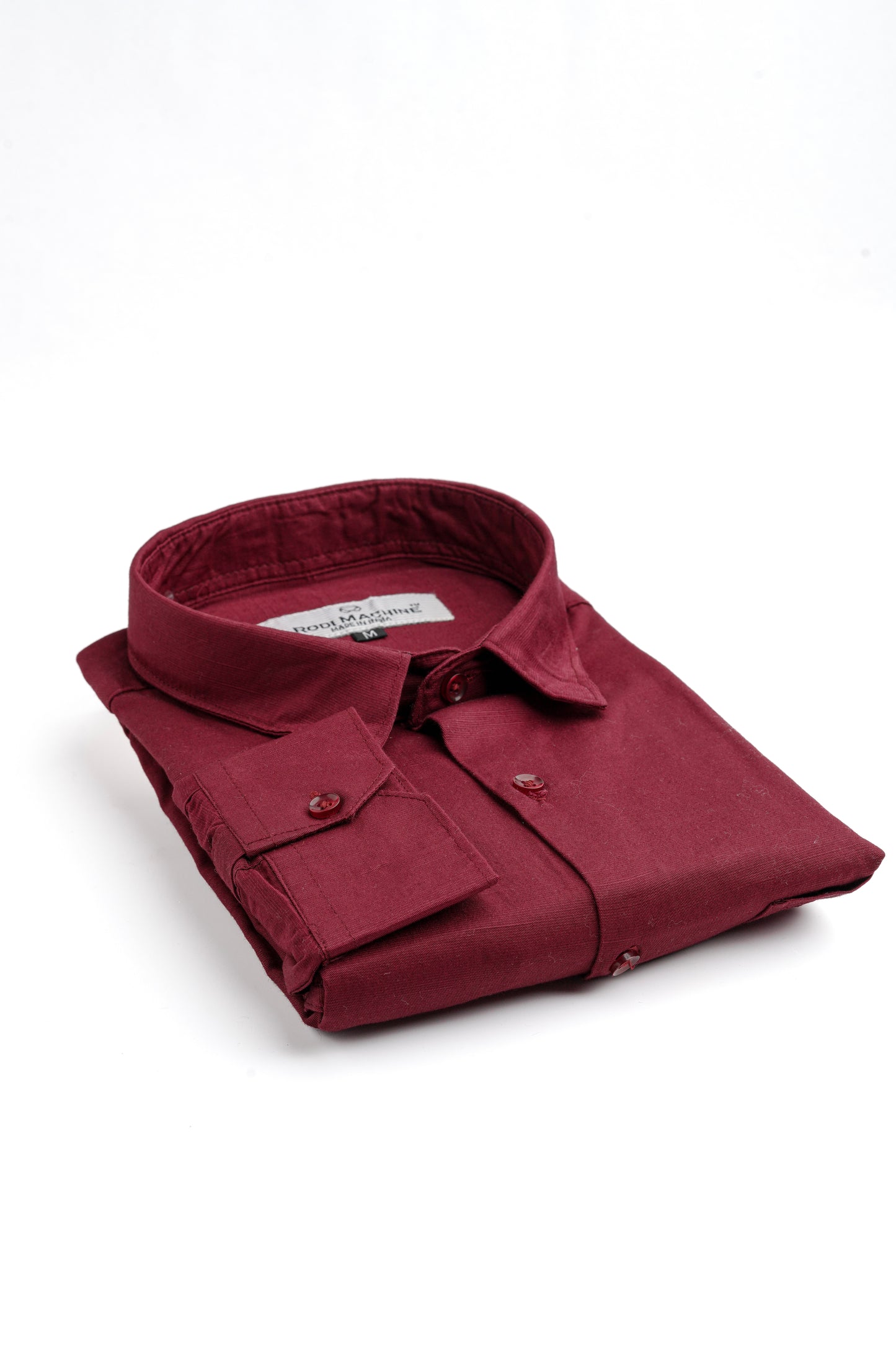 Folded Maroon colour Rodi Machine shirt on a white background