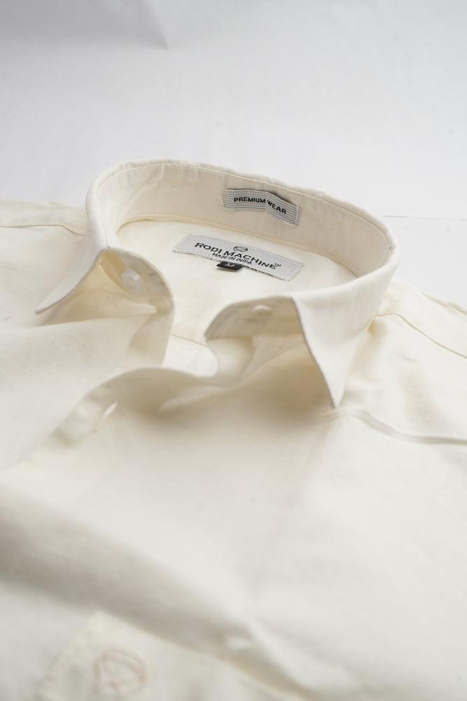 Close-up of a Milky White colour Rodi Machine shirt with a brand label on a light gray background