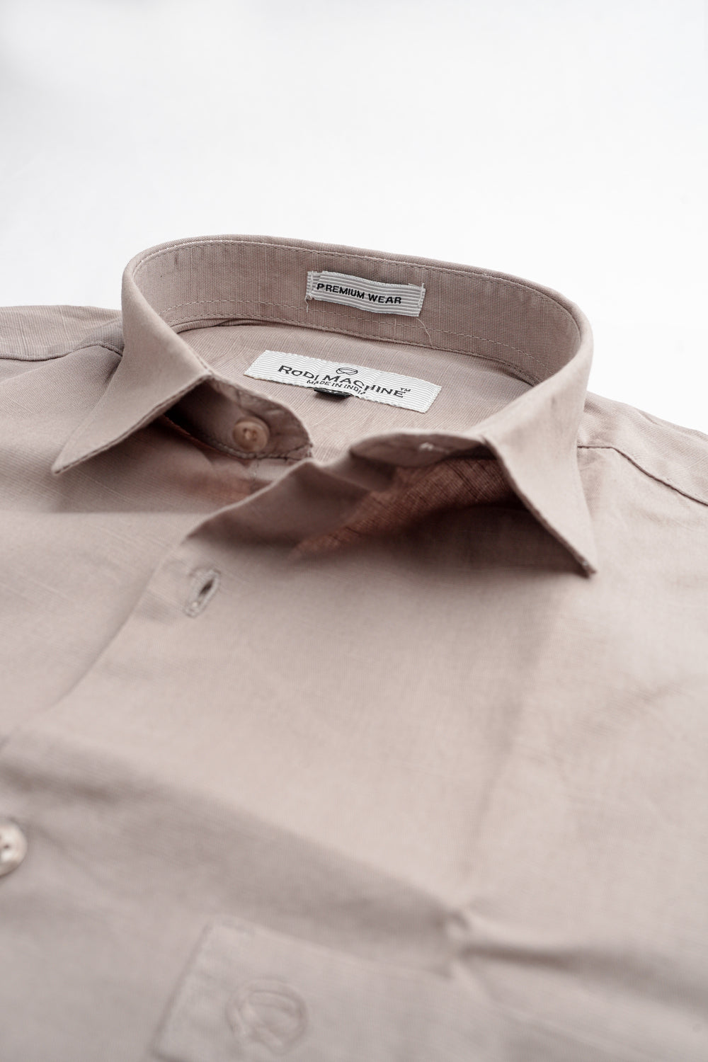 Close-up of a Dark Grey rodi machine shirt with a collar and label on a white background