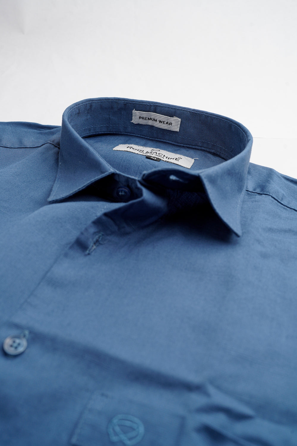 Dark Blue colour Rodi Machine shirt with collar and brand label on a light gray background