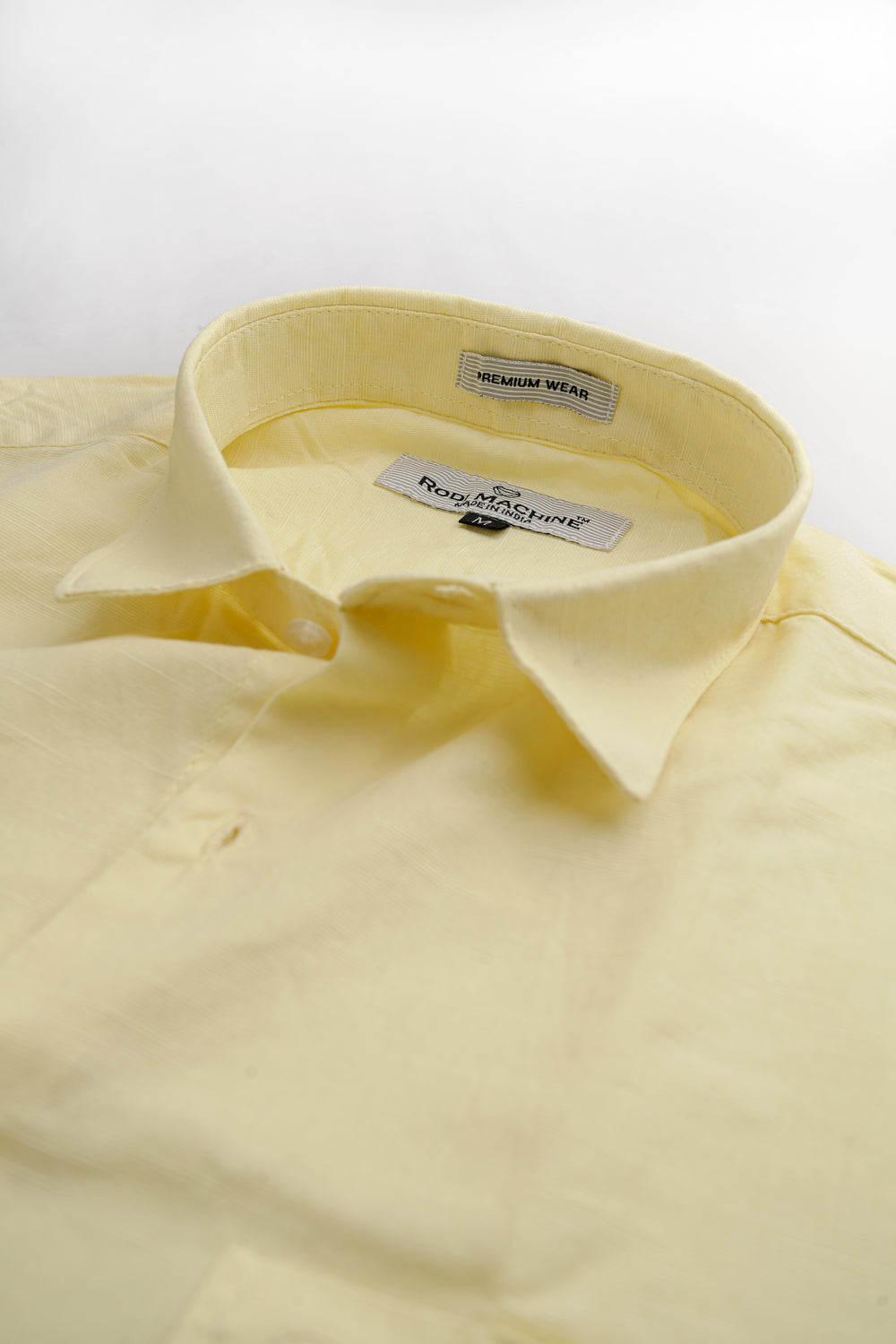 Yellow colour Rodi Machine shirt with collar and brand label on a light gray background