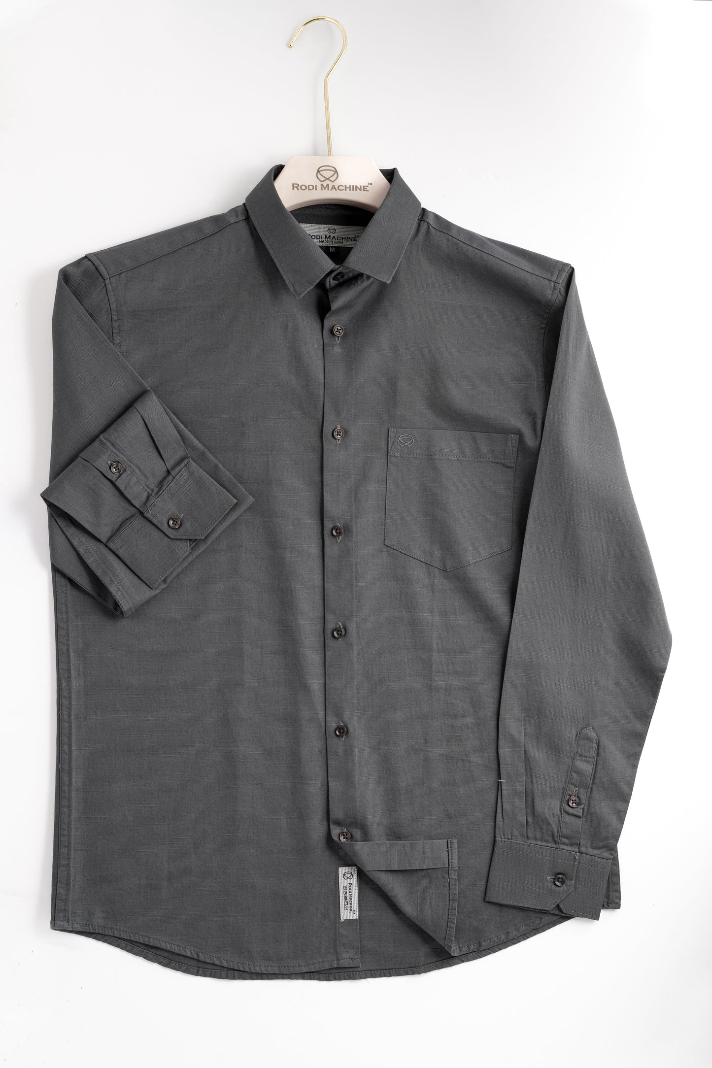 Ash colour Rodi Machine shirt on a hanger against a white background