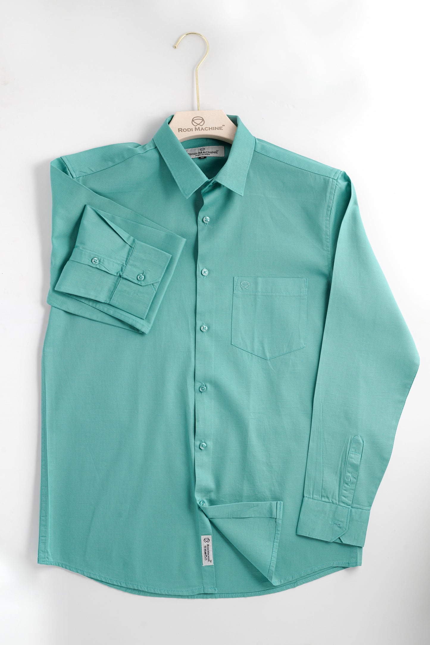 Cian colour Rodi Machine button-up shirt on a hanger against a white background