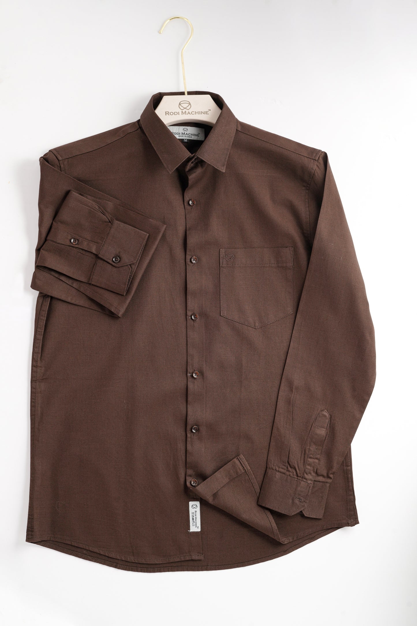 Hanging Brown colour Rodi Machine shirt on a white background