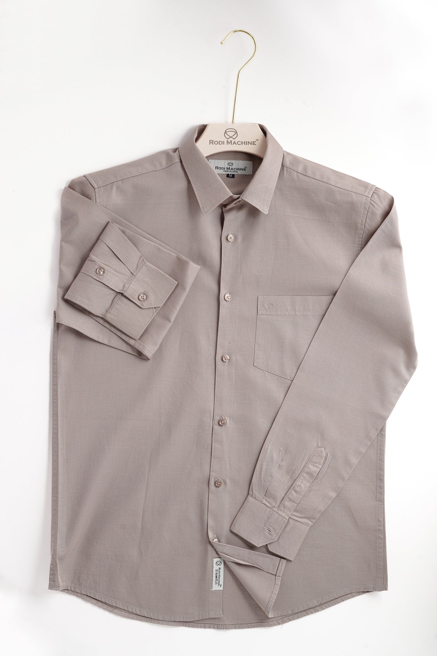 Dark Grey Rodi Machine shirt on a hanger against a white background