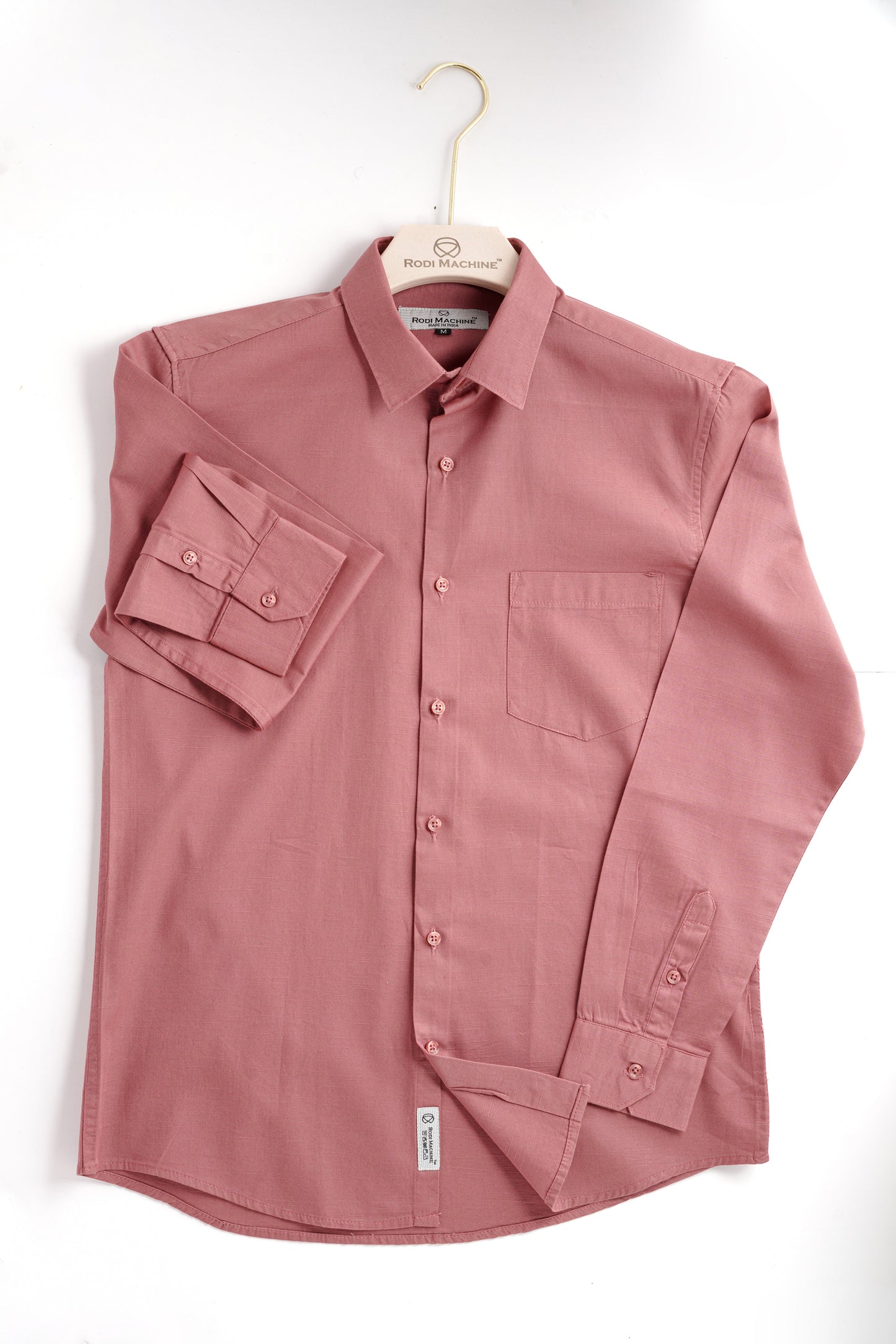 Red wood colour Rodi Machine shirt on a hanger against a white background