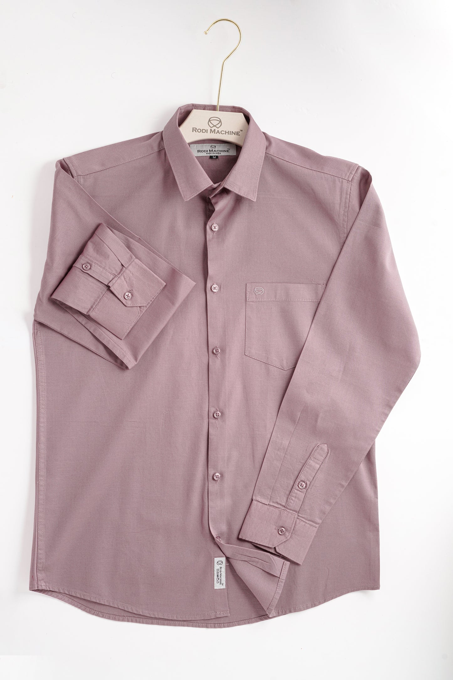 Lavender colour Rodi Machine shirt on a hanger against a white background